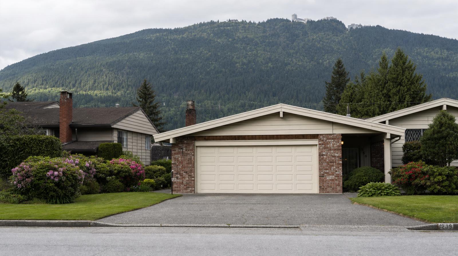 Quiet Burnaby residential street with split-level homes and Burnaby Mountain in the background